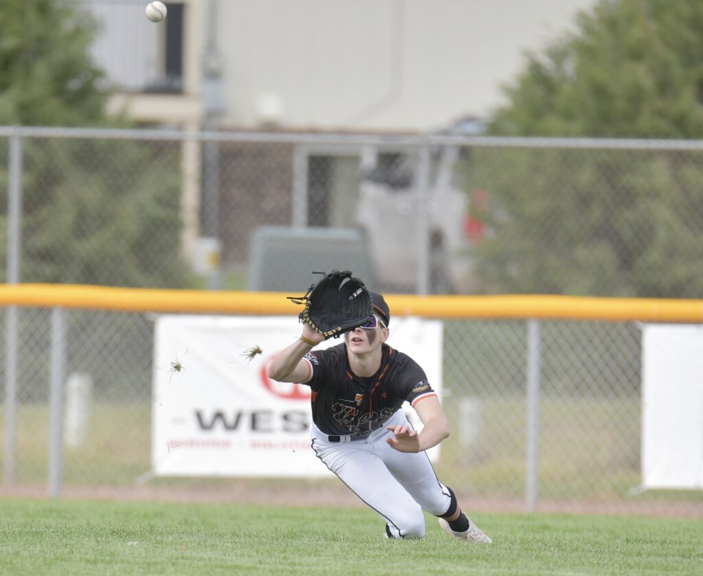 Tigers right fielder Mac Hibben dives to make a catch in the first inning of Friday’s 15-3 victory over the Rawlins Generals. Andrew Towne/Torrington Telegram