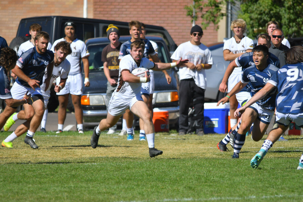 Andrew Towne/TORRINGTON TELEGRAM
University of Wyoming senior Josh Posten (center) carries the ball down the field trying to avoid Utah State defenders in the first half of Saturday’s rugby match in Laramie.