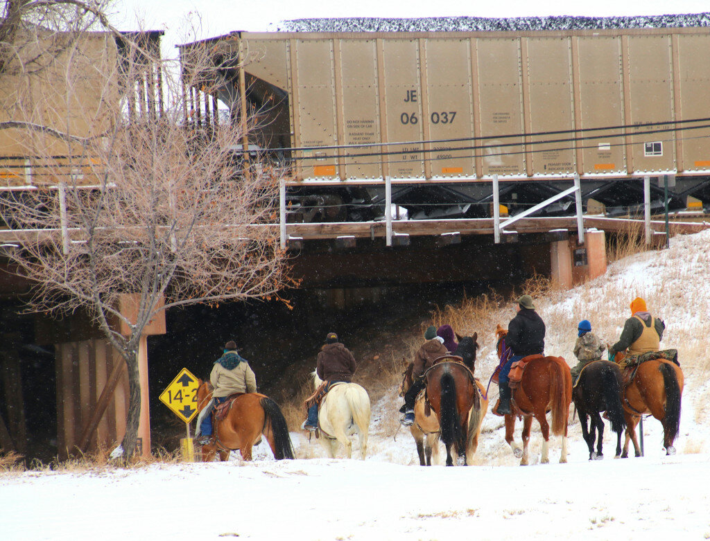 The Pony Express riders consider their trek under the railroad trestle in Guernsey Saturday. They rode hard to Hartville through snow and single digit temperatures to make sure that Valentine’s Day cards would be delivered on time.