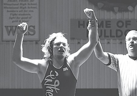 Bulldog Tyrrell Weber (r) is announced victorious after his match against a Glenrock opponent.