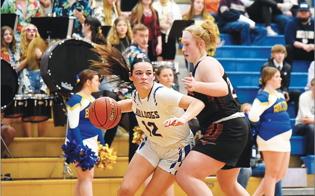 Senior Kacey Otero, No. 12 (left) drives past Newcastle defense. Otero was named Sportsman of the Game Saturday night.