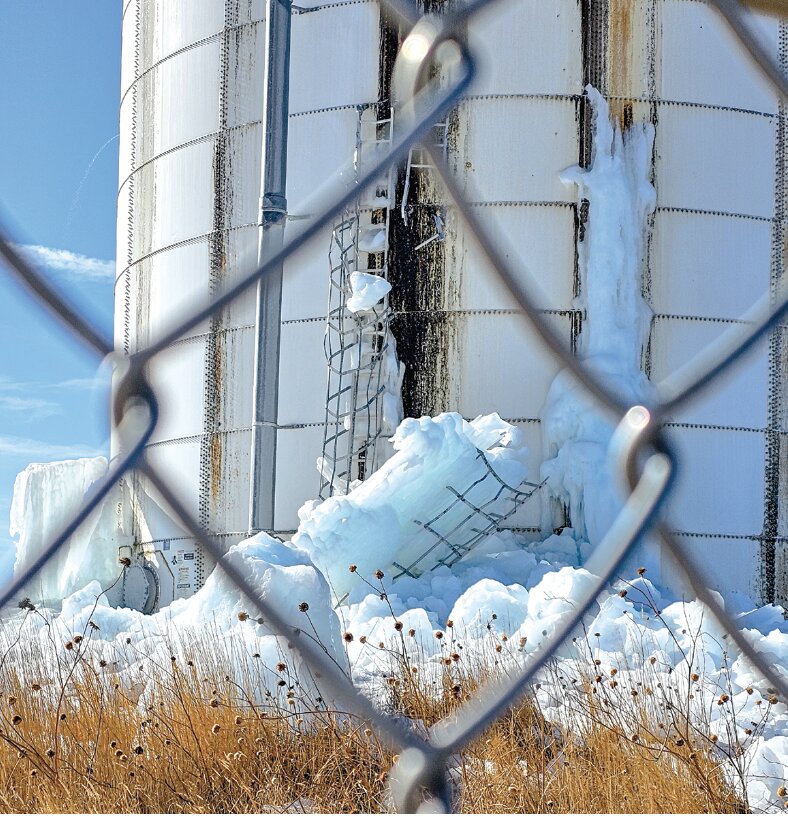 A Black Mountain water tower ladder can be seen suspended in ice.