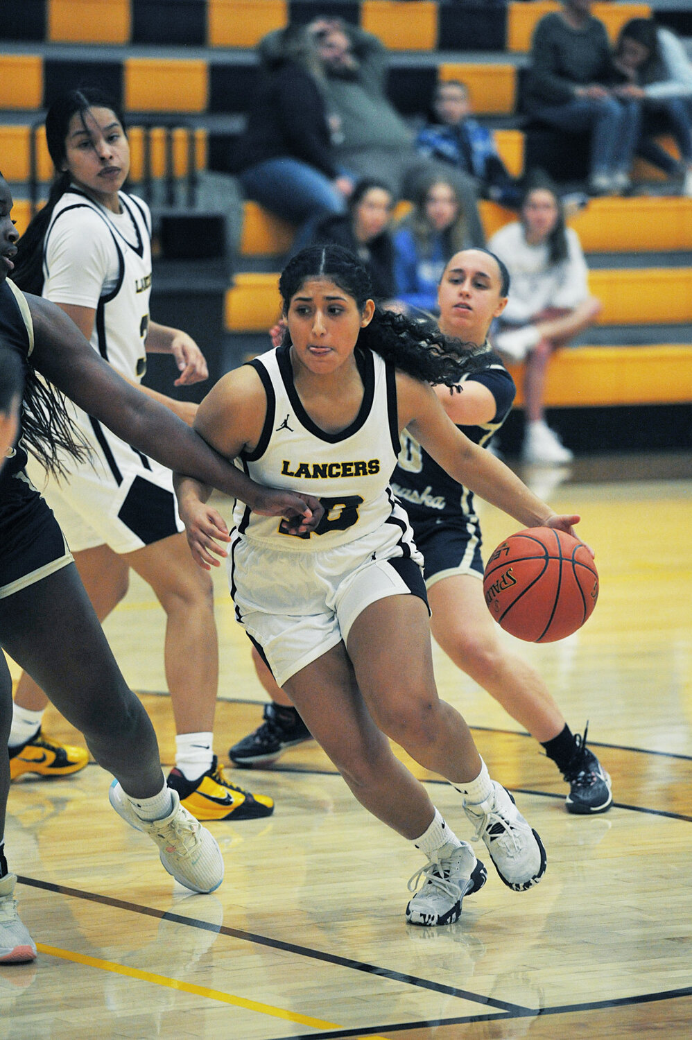 Freshman guard Luna Moreno maneuvers through WNCC’s perimeter on January 8. Moreno led the Lady Lancers in scoring against WNCC with 15 points. Also pictured is Tawny Rodriguez in back.
