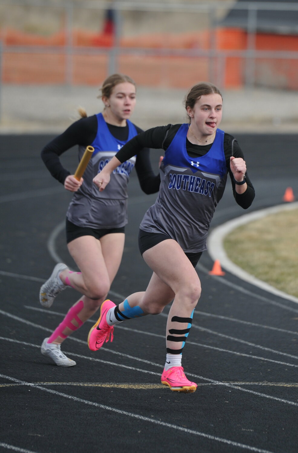 Sophomore Molly Hasbargen hands the baton off to senior Sasha Haines in the 4x100-meter relay. The team placed seventh overall.