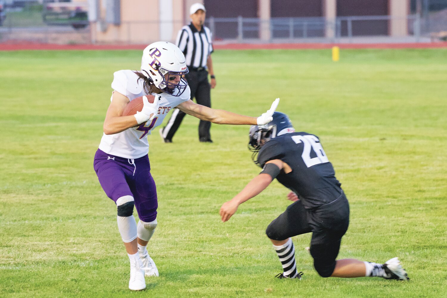 Jayden Wagner-Gross (26), a sophomore defensive back, is stiff-armed by the Pine Bluffs offense during the game this weekend in Guernsey.