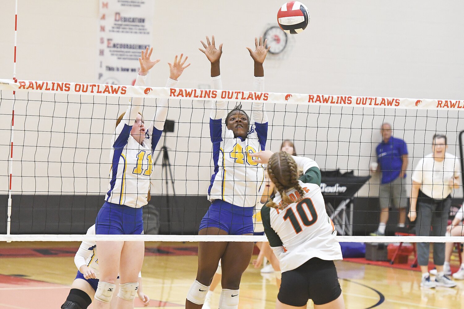 Camryn Mickelsen (11) and Desirae Iacovetto (40) block an incoming volley from Pinedale earlier in the season.