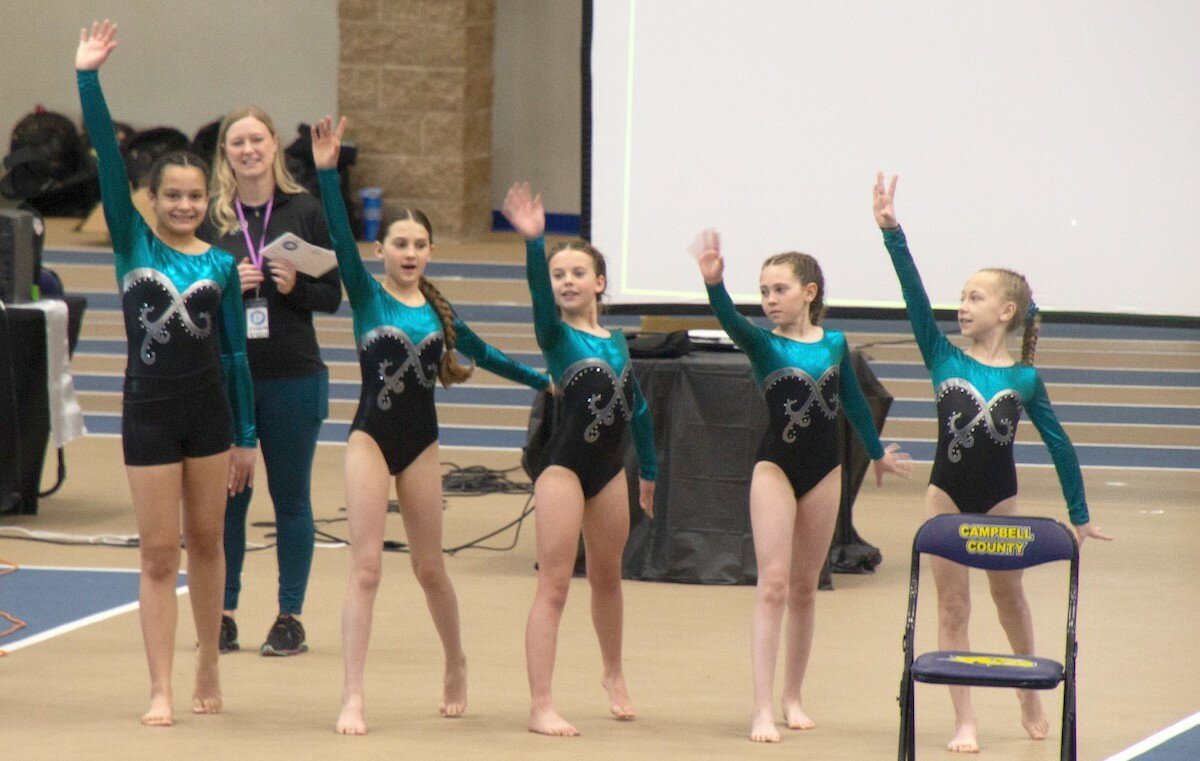 The Silver Xcel team of Mile Martinez (left to right), Sarah-Jo Goddard, Gianna Pavone, Maggie Goddard and Natalie Sampers present during the opening ceremony of the silver competition while coach Kristen Gordon looks on.