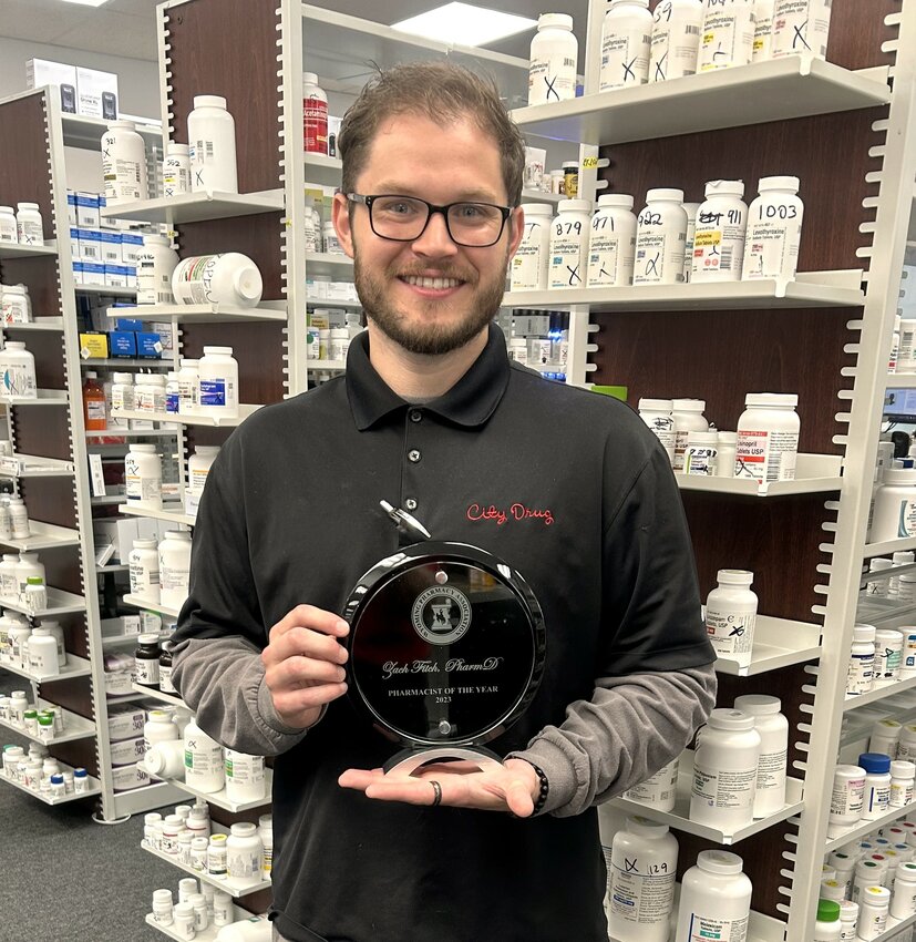 City Drug pharmacist Zach Fitch shows the Pharmacist of the Year award he received during last month’s Wyoming Pharmacy Association convention in Thermopolis.