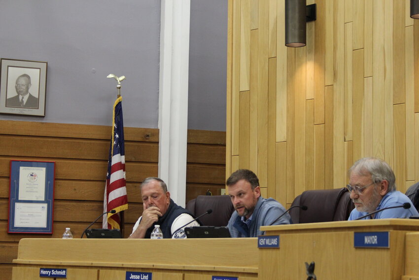 During council comments at the Tuesday, March 4, city council meeting, councilmember Jesse Lind gives a statement in response to the investigation findings delivered to him earlier by Evanston City Attorney Mark Harris. Also pictured are councilmembers Henry Schmidt and Evan Perkes.