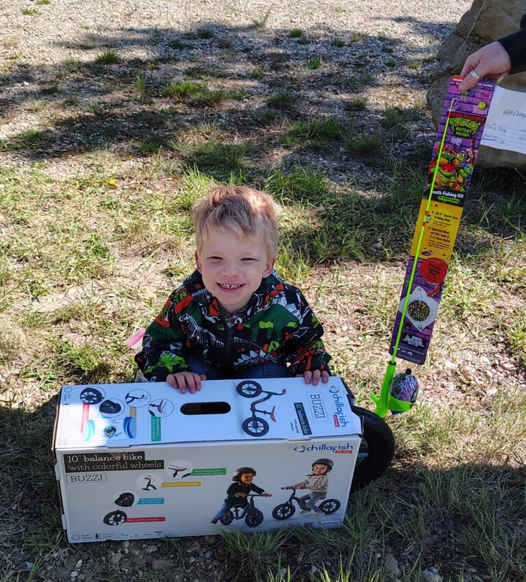 Bridger Biebinger shows his loot after taking first place in his class at the June 7 youth fishing derby in Kemmerer.