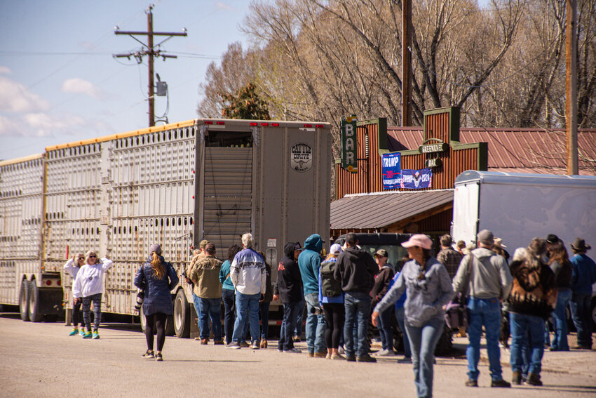 Folks from near and far gather in front of the Green River Bar in Daniel, obstructed slightly in this photo by the two dirty livestock transport trailers parked bumper to bumper in front of the bar. An estimated 200 people were on the ground in Daniel for the May 26 Hogs for Hope ride, including many members of the media, independent camera crews and local law enforcement.