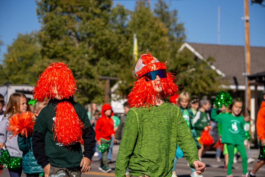 Parade participants get creative with their school spirit, choosing to don their bright orange pompoms as wild hairstyles.