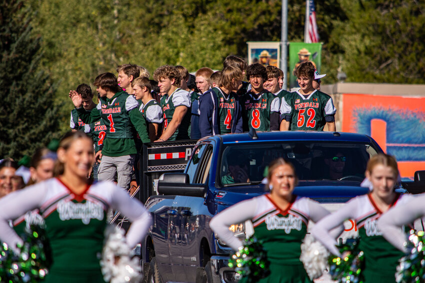 Members of the PHS Wrangler football team, flanked by the cheerleaders, engage with spectators during the 2024 Homecoming Parade on Friday, Sept. 20. 