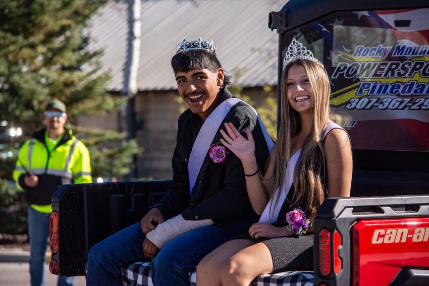 Alex Hernandez and Haley Layne, Skyline Academy’s Homecoming King and Queen, wave to the crowd as they cruise through town. 
