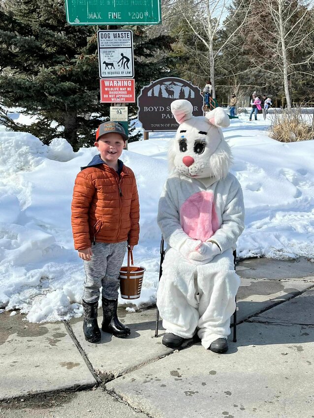 The Easter Bunny visits with a young egg hunter during the Pinedale Lions Club annual Easter Egg Hunt in Boyd Skinner Park last year. This year’s egg hunt is planned for Saturday, March 30 beginning at 10 a.m., with much less snow expected.