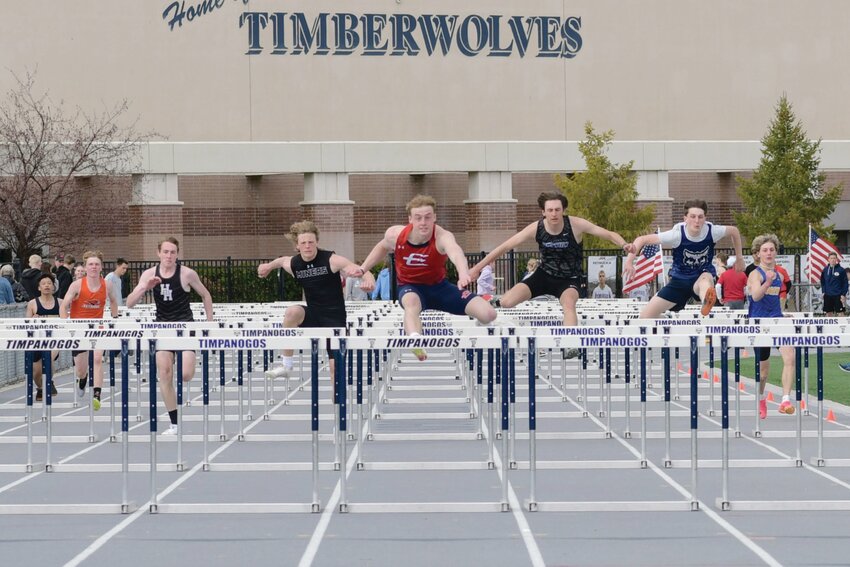 EHS hurdler Kai Barker leads his heat Wednesday during the prelims at the Alpha Invitational at Timpanogos High School in Orem, Utah. Barker went on to finish second overall in the event, while the Red Devils finished third as a team.