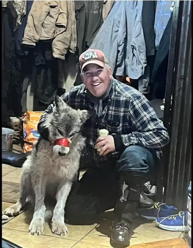Cody Roberts, 42, of Daniel, holding a beer and grinning, poses with a female yearling wolf whom he allegedly tortured. The father of four is accused of chasing down the wolf on his snowmobile, running her over to immobilize her, duct-taping her mouth shut, having his hunting dogs take turns attacking her and bringing her into the Green River Bar before shooting her. Although other media outlets reported this photo as taken inside the bar, upon inspection the Roundup believes it was taken inside the mudroom of a residence rather than the bar. No reproduction without written permission.