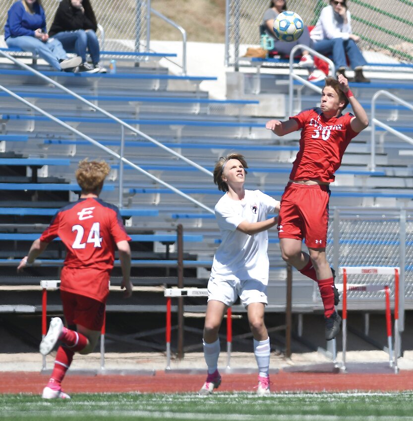 Red Devils forward Brooks Searle just misses on a scoring opportunity Saturday during Evanston’s 3-1 loss to Natrona County. The Mustangs’ goalkeeper Zach Hawley made the stop on the play, aided by defenseman Arath Renteria.
