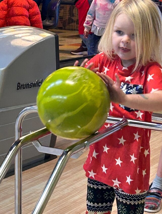 Big Piney’s Harper Ott uses both hands and a bright green bowling ball to knock down pins at the third annual Children’s Learning Center Bowling Day on April 13. Ott was the top scorer for the Big Piney Children’s Learning Center, with 107 points.