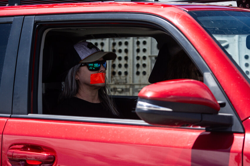 A supporter of the Hogs for Hope effort to change legislation regarding the treatment of predators in Wyoming is seen with red duct tape over her mouth during the May 26 ride through Daniel. Many supporters of the cause wore red tape over their mouths or on their clothing while speaking as a reminder of the red duct tape used to muzzle the wild gray wolf captured by Cody Roberts.