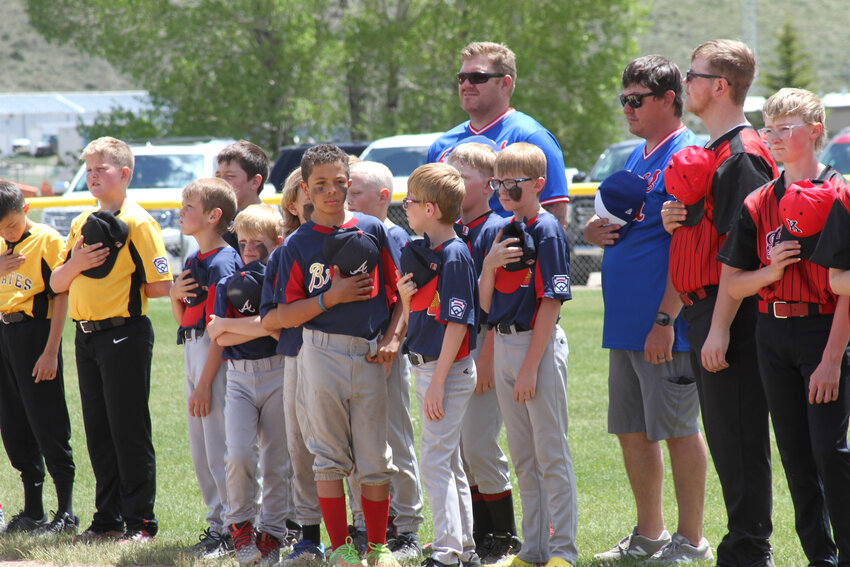 Members of the Braves Little League Majors team cover their hearts during the National Anthem at Kemmerer Little League’s A Day at the Ballpark event, held on June 8.