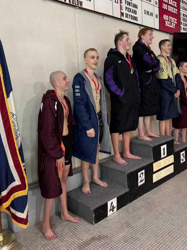 Red Devil swimmer Jacob Olson takes his spot on the podium following his 4th-place finish in the 500 freestyle Saturday at the 4A State Swimming and Diving Championships. Olson posted a time of 4:58.44.
