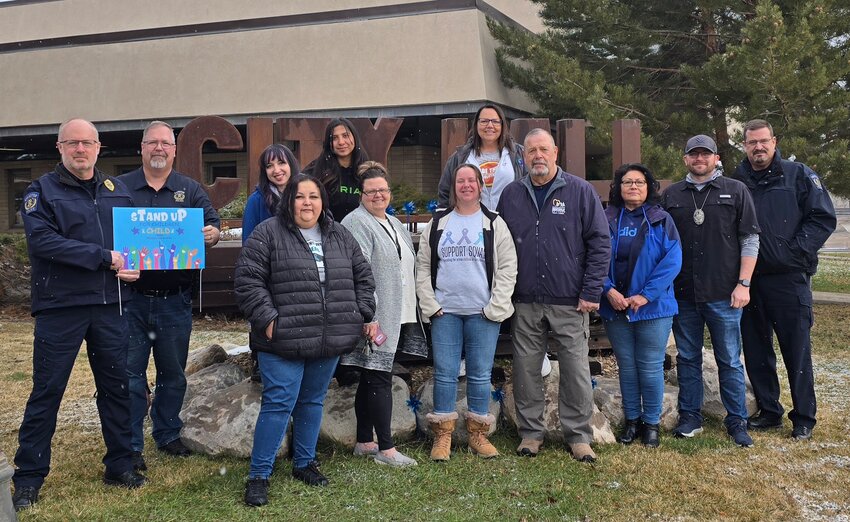 Town of Bear River officials and advocates show their support for National Child Abuse Awareness Month. Pictured are Nadine Hijar with SAFV Task Force and AmericCorps VISTA, SAFV Task Force Bridger Valley advocate Amber Elespuru, Uinta County Sheriff’s Office Victim Witness Coordinator Gina Sundquist, Uinta County Sheriff’s Office deputy Nate Skaggs, Bear River Town Councilmember Margaret Huggins, EPD Victim Witness Coordinator Vanessa Weekly, Bear River Town Clerk/Treasurer Barb Couture, SAFV Task Force advocate Adelaida Rameriez, SAFV Task Force advocate/administrative assistant Jade Zuehlsdorff and Uinta County Sheriff’s Office deputy Kyle Wilkins.