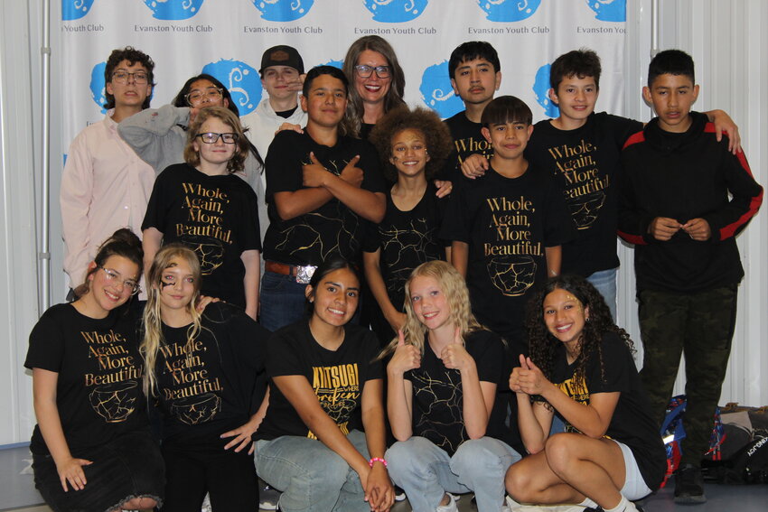 Some of the Evanston Youth Club members gather around CEO Holly West after the club’s annual awards dinner to celebrate.