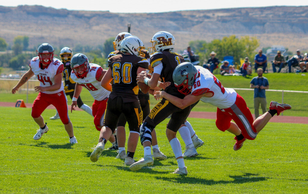 Sadie Snively photo
A powerful Puncher defense shut out Rocky Mountain during the Sept. 9 conference game. Pictured are senior Roger Young, No. 60, making the tackle, along with seniors Zack Murphy (No. 78) and Preston Bennett (No. 44).