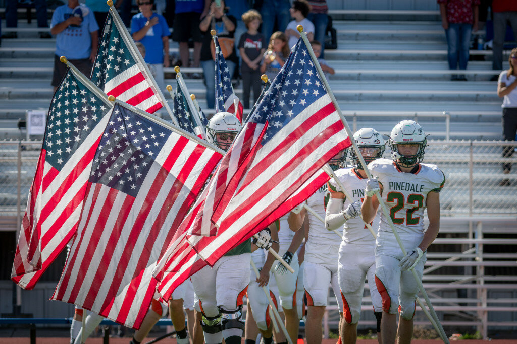 Sandy Wanfalt photo
Senior Jake Hammer, No. 22, leads the Wranglers onto the field against Lyman on Friday, Sept. 8. Both  Pinedale and Lyman carried out an opening ceremony to honor veterans before the game.
