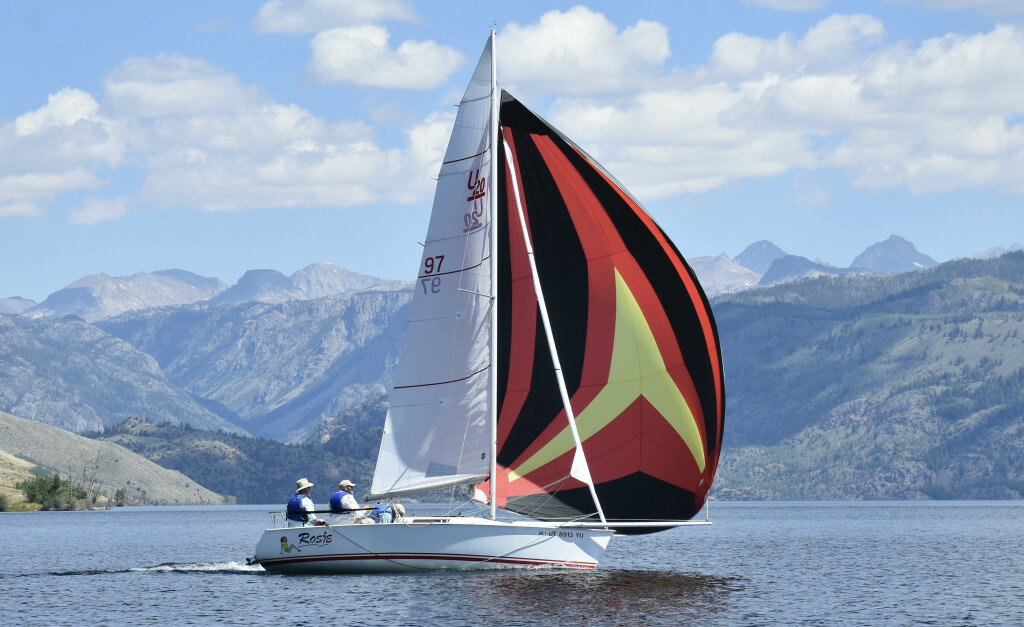 Robert Galbreath photos
The ‘Rosie,’ an Ultimate 20 crewed by David Pendell, Pat Sullivan and Howard Bartlett, cruises beneath the Wind River Range on the first race of the 54th Annual Sailing Regatta on Aug. 12. The vessel snagged second place in the cruiser division.
The ‘Royal Flush,’ a Capri 22 piloted by Randy Bick, Jon Peek and Joe Lison, unfurls its sails as it heads toward the second turn in the racecourse on Saturday.
Three sailboats race for the finish line on Saturday. From left, the ‘Hansen,’ crewed by Eric, Erica, Rachel and Mary Hansen; the ‘Time Traveler,’ piloted by Monte Bolgiano, Leeland Crozier and Dylan Bear and ‘Opa’s Dream,’ crewed by Jason Essington, David Payne and Terry Van Valkenburg.