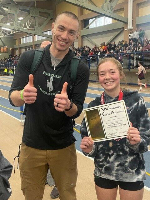 Courtesy photo
PHS sophomore Madison Antonino proudly displays her All-State award with Head Coach Kyle Sullivan at the State Meet in Gillette on March 3. Antonino won the 3A state championship in the 3200-meters, posting the fastest time out of all classifications at the event.