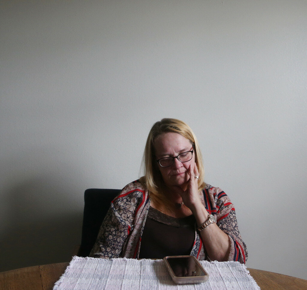 Cayla Nimmo, Casper Star-Tribune photo
Patty Edwards sits at a table in her home in Casper Wednesday, May 26, 2021. On the table lies her cell phone full of photos of her husband, Victor.