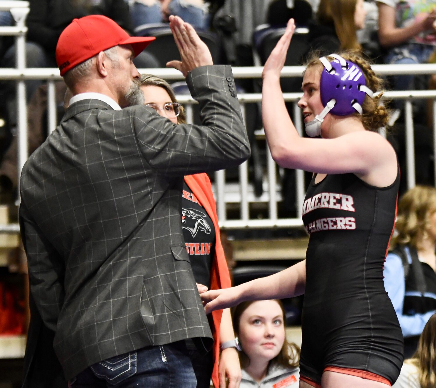 Lady Ranger Kaylie Julander high-fives her coach after winning the 140-pound State Championship Saturday at the Ford Wyoming Center in Casper.