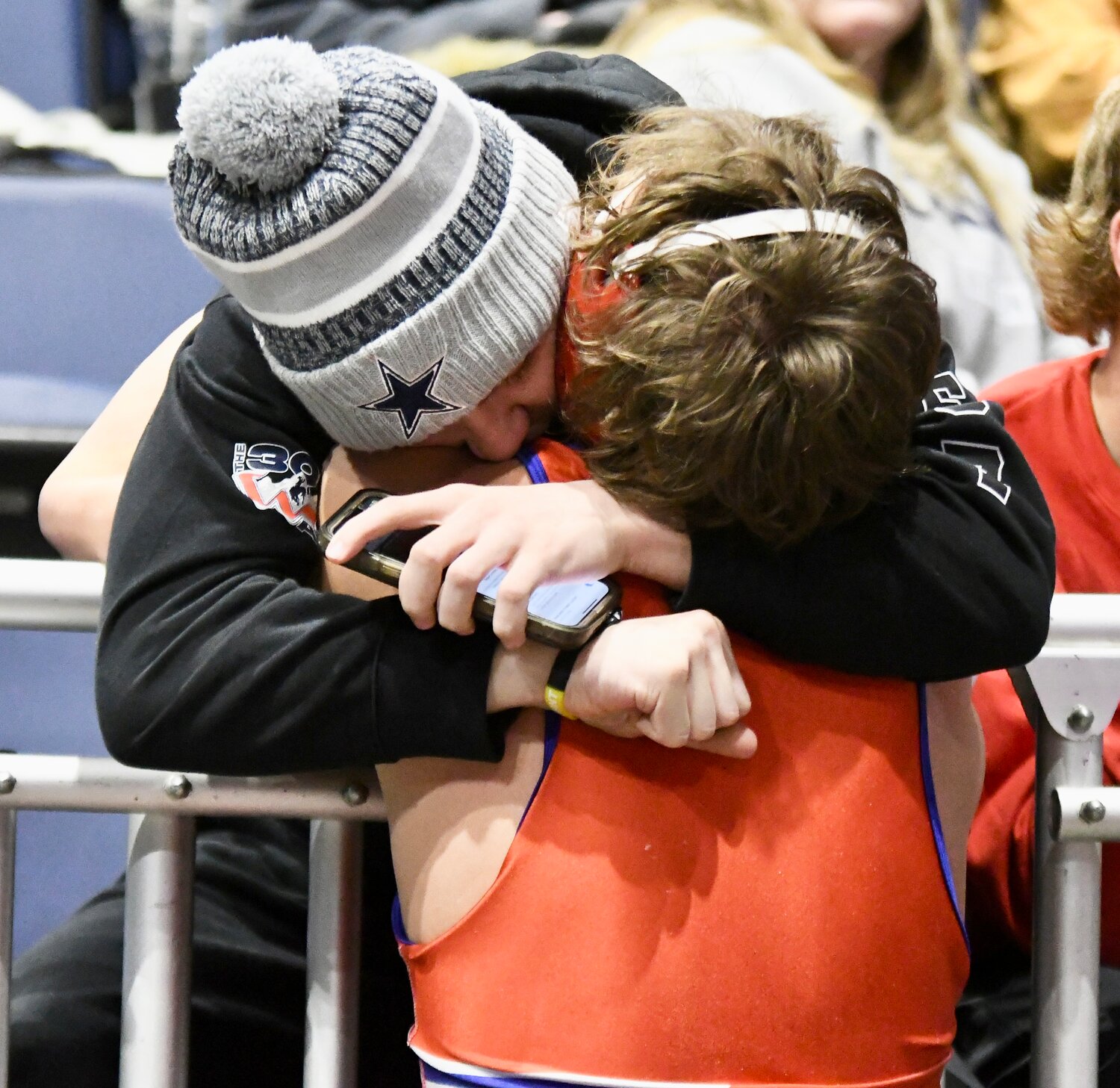 Newly-crowned 175-pound State Champion Brady Roberts goes into the stands to hug his younger brother Bridger, following his 3-0 victory over Buffalo’s Hazen Camino.