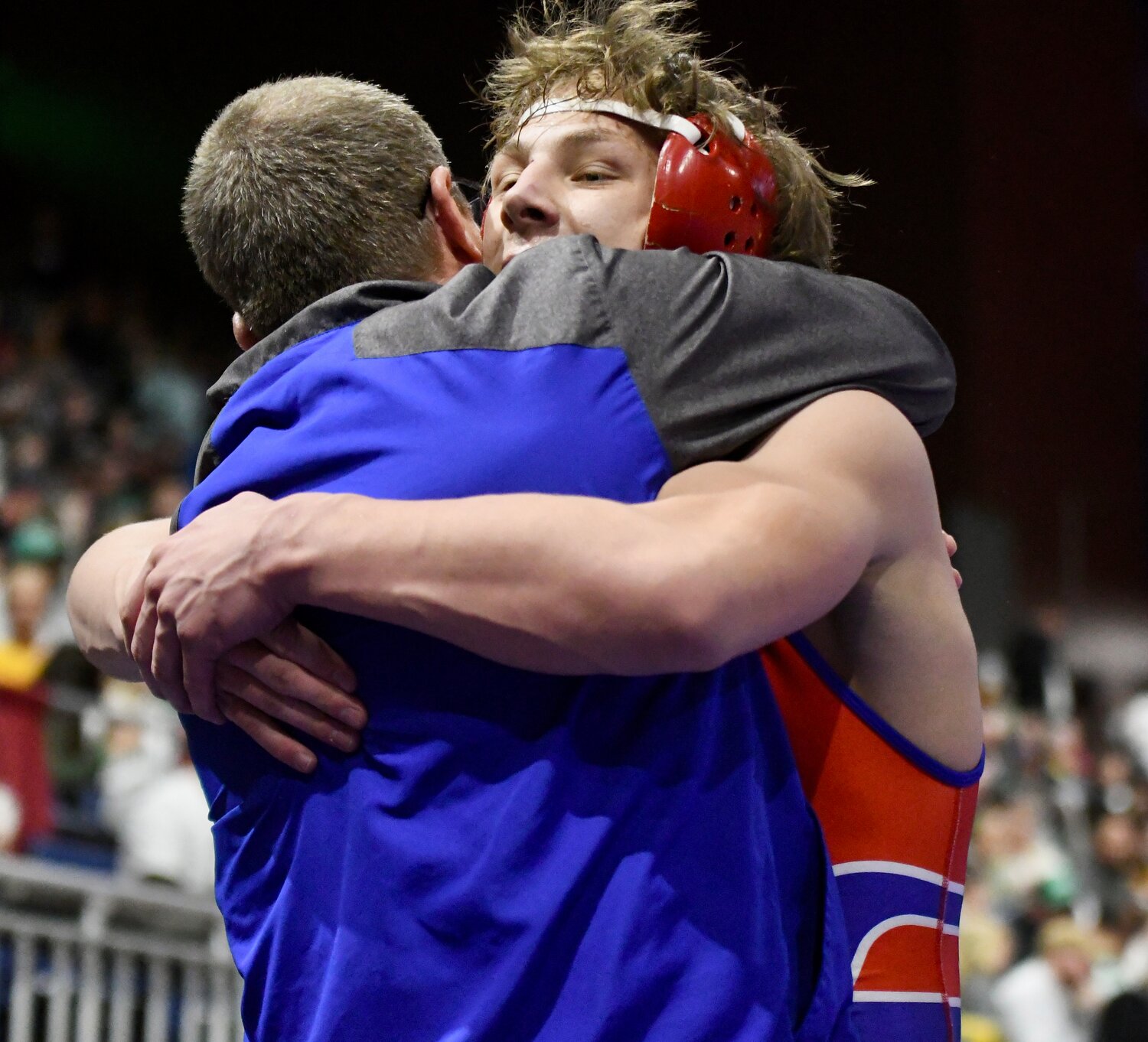 Red Devil Brady Roberts hugs coach Garth Wagstaff after winning the State Championship at 175 pounds.
