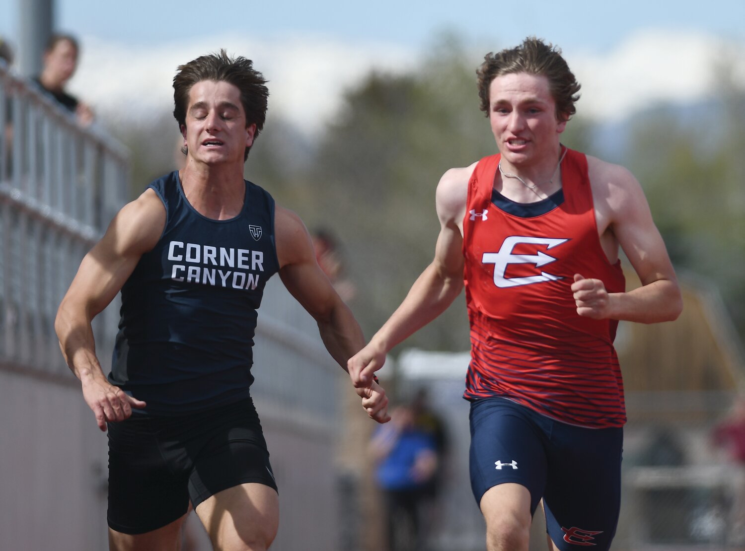 Red Devil sprinter Gabe Hutchinson keeps pace with Corner Canyon’s Preston Rasmussen in the invited 100 meters at Saturday’s Davis Invite in Kaysville, Utah. Hutchinson finished 7th.