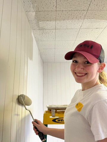 Janelle Sawaya helps paint the interior of the Hamsfork Museum thanks to the local Rotary Club and fellow volunteers from the KHS Interact group.