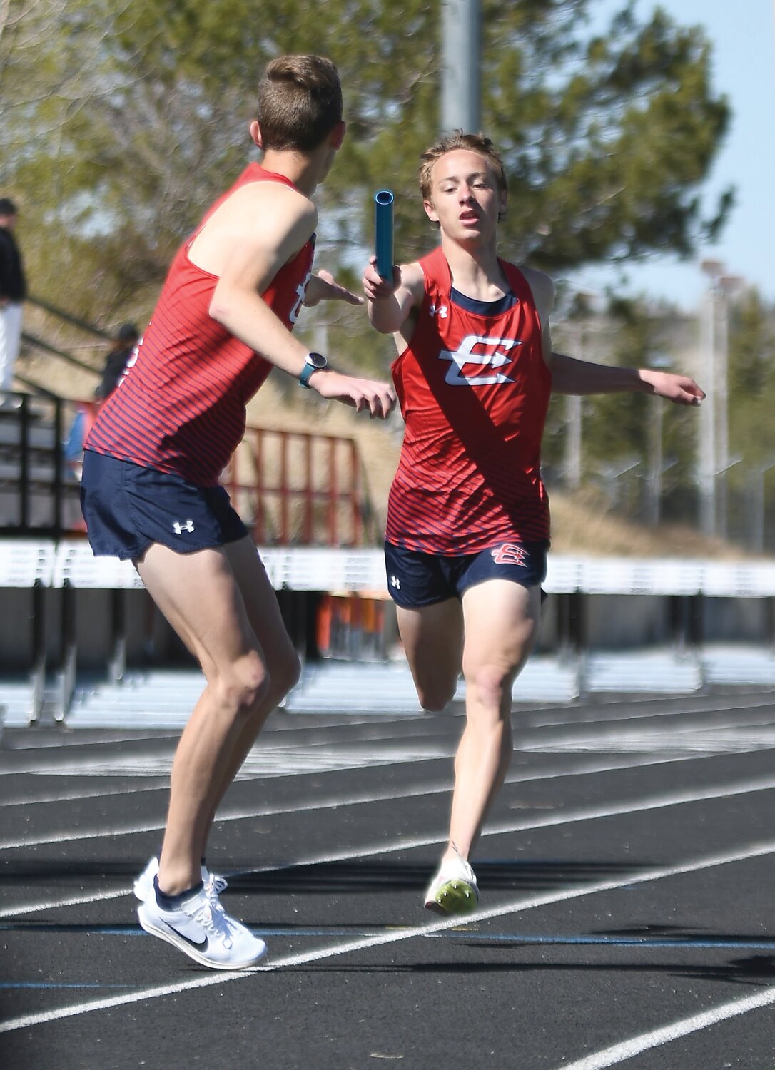 Aidan Conrad hands the baton off to Paul Baxter during the 4x800 Saturday at the 4A West Regional Meet in Rock Springs.