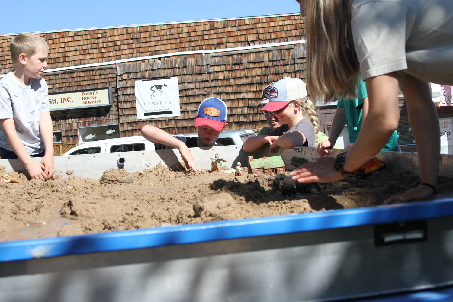 Kids play and learn with an interactive stream simulation table during Outdoor Discovery Day, held Saturday, Sept. 7, at Triangle Park.