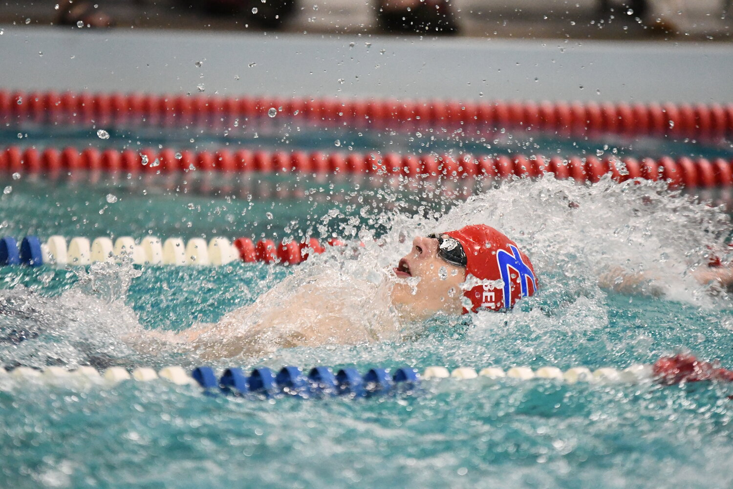 Red Devil swimmer Hyrum Bell swims to a second-place finish in the 100 backstroke at Saturday’s 4A West Conference Championship, held at Davis Middle School. Bell earned All-Conference honors for both the backstroke and the 100 freestyle, finishing second in both.