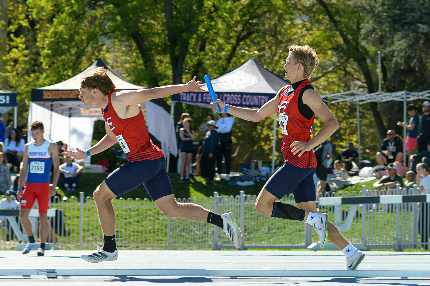 Red Devil sprinter Timber Fitch hands off the baton to teammate Jayden Rieker in the 4x100 relay at Saturday’s BYU Invite. Fitch and Rieker — along with teammates Brayden Wallace and Ayden Hartzell — broke their own school record in the event, posting a time of 42.81; they previously broke the record last Tuesday at the Schuler Invitational.