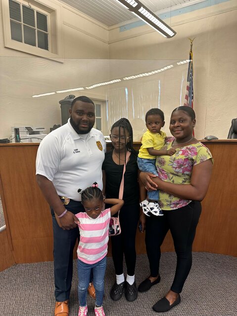 Shawn Howze is sworn in as full-time chief of the Blackville Police Department alongside his wife and children. Howze was hired as interim chief earlier this year.