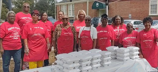 The Together Sisters serve drive-thru meals to seniors outside the Blackville Community Center.