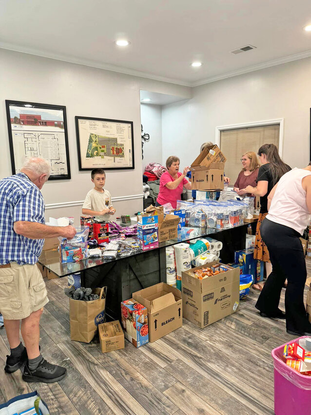 Volunteers pack care packages for victims of Hurricane Helene. These packets and other supplies will be delivered to North Carolina, one of the hardest hit areas.