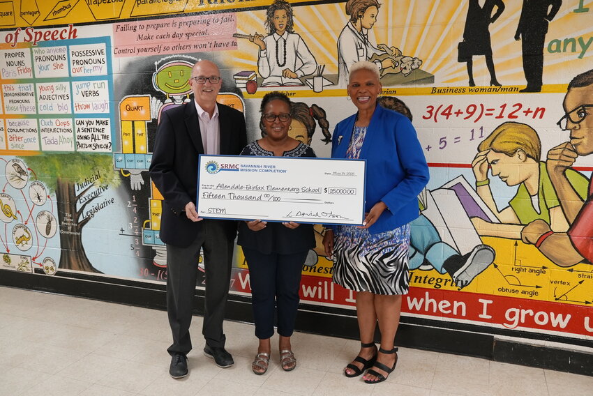 Savannah River Mission Completion President and Program Manager Dr. Dave  Olson (left) presents a $10,000 donation to Allendale-Fairfax Elementary School Principal  Sheila Leath and Superintendent Dr. Valerie Cave.