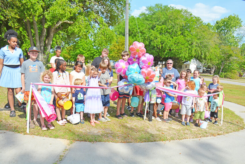 Children cut the ribbon to the new TRACK Trail in the Town of Hilda on April 19.