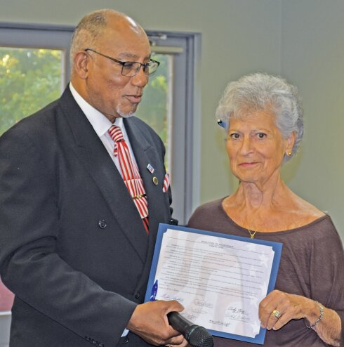 Barnwell County Council Chairman Freddie Houston presents Cheryl Long a resolution of recognition for her years of service to the county.