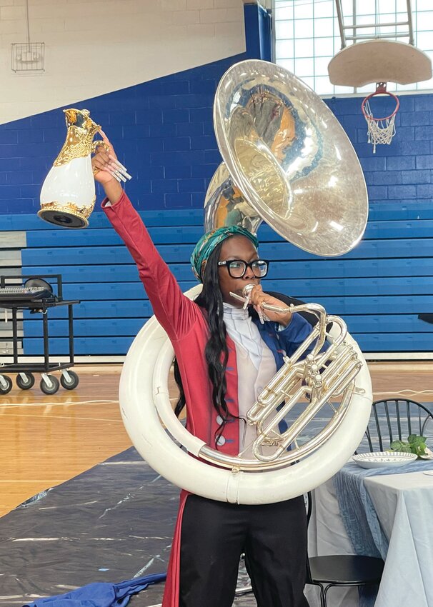 Nakoma Madyun holds a prop while playing her instrument during an April practice.