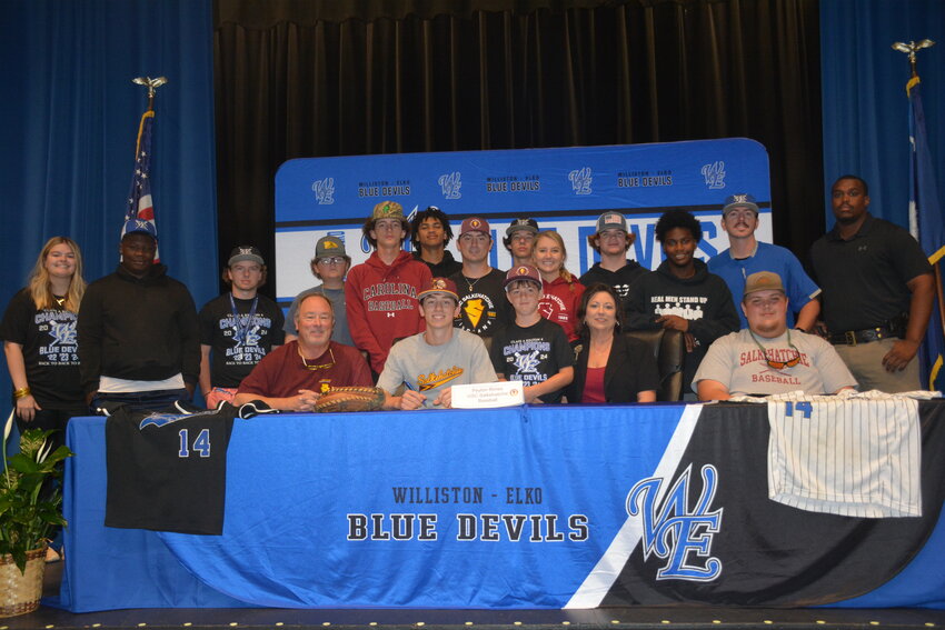 The Blue Devils baseball team joins Peyton Rimes and his family for a photo during his signing ceremony to play baseball at USC Salkehatchie.